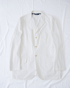 CALCÈLのPolo by Ralph Laurenオフホワイトの3つボタンシングルジャケット。斜め畝生地でノッチドラペルとパッチポケット付きのゆったりとしたシルエット。
